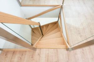 Sicht auf eine Holztreppe von oben in einem modernen Haus.